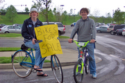 Boys selling their bikes... wearing 'bikes for sale' signs.