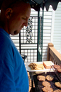Jim cooking burgers and hotdogs.