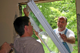 Dave and Joel preparing to set the new window in the spot where the old window was.