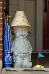 Ceramic pig dressed up as if he's prepared for a round of golf.