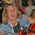 Jeffrey Steele singing and playing his guitar at the Bluebird Cafe in Nashville, Tennessee.