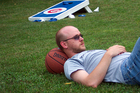 Jerry resting on a basketball in between Cornhole games in the backyard.