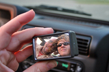 Self-portrait of the two of us through one of those little concave 'blind spot' mirrors... taken while driving in our Jeep!