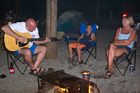 Jim strumming some campfire songs. Little boy to his mother: 'Mom, I don't think he knows any songs!'