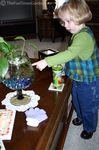Karly pointing to her fish in the fishbowl.