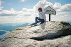 Lynnette sitting atop Whiteface Mountain in Lake Placid, New York.