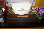 Lynnette's desk with homemade nameplate from Scrabble tiles.