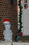 The neighbor's ceramic pig wearing a Santa hat.