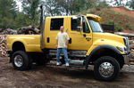 Randy standing on the running boards of a brand new International CXT ...notice the watermelons growing on the dirt pile in the background!.
