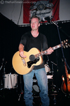 Shawn Mullins tossing a guitar pick into the audience.