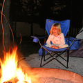 Sophie sitting by the campfire.