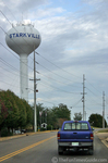Mike driving his truck past the water tower in Starkville Mississippi near the Mississippi State University campus.