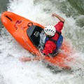 A whitewater freestyle kayaker using his hands as paddles at Hell's Hole on the lower Ocoee River.