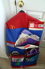 A clever wrapping paper & supplies holder that utilizes a multi-pocketed bag that hangs on a clothes hanger in your closet.