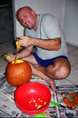 Jim carving out the goo from the inside of a pumpkin