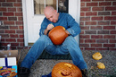 Jim using a template to carve a pumpkin.