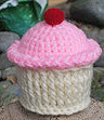 White cupcake pin cushion with pink frosting.