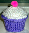 Purple cupcake pincushion with white frosting.