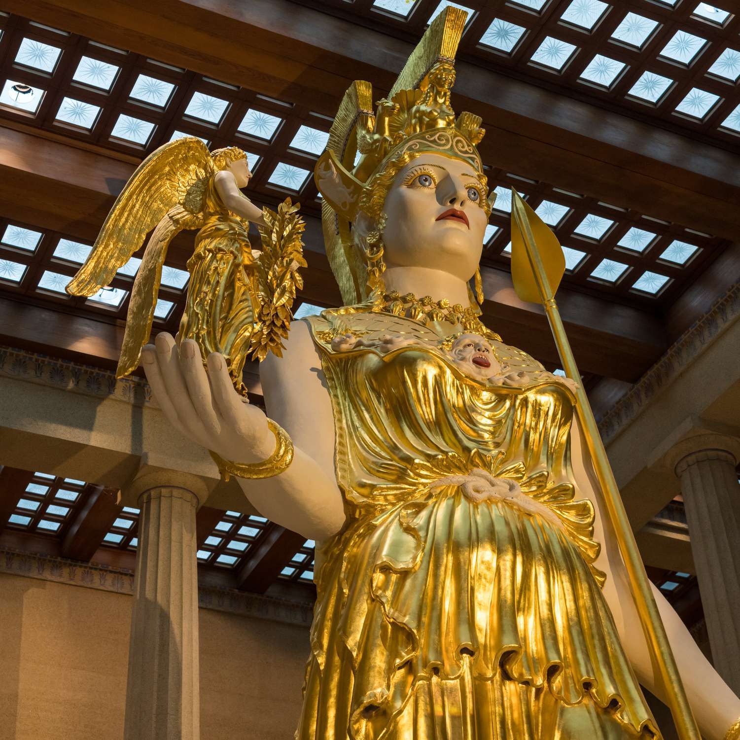 My kids standing in front of the Athena statue inside the Nashville Parthenon museum. photo by Jenn at TheFunTimesGuide.com