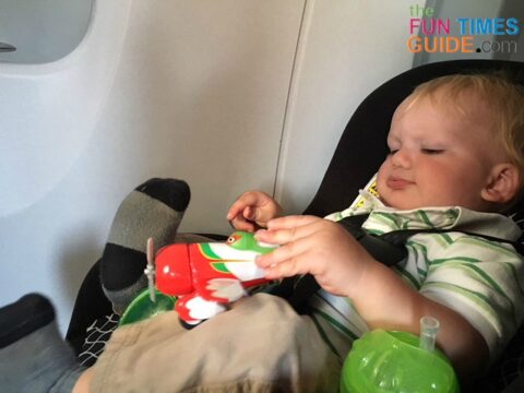 My son enjoyed flying on an airplane in his car seat (after we scored an extra seat). photo by Candida at TheFunTimesGuide.com My son enjoyed flying on an airplane in his car seat (after we scored an extra seat).
