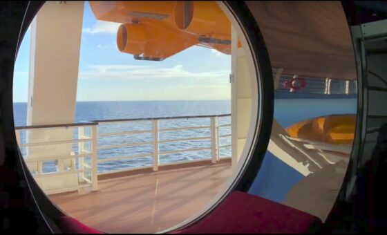 A look out of one of the large porthole windows on the Disney Dream cruise ship.