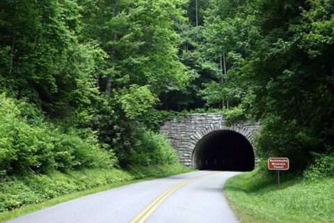 downhill-driving-tips-winding-road Approaching a dark tunnel on a dangerous mountain road - see how to use your brakes properly.