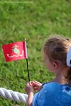 A little girl waving a U.S. Marine flag.